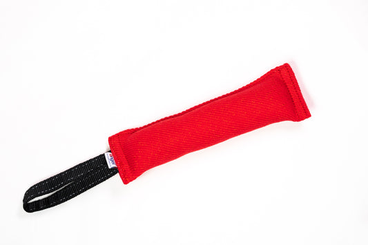 Red tug toy with black handle on white background