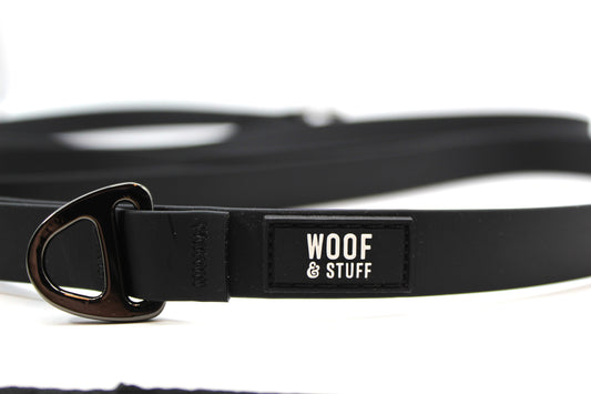 Black dog leash with 'Woof & Stuff' label.