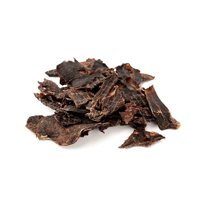Pile of dried jerky on a white background.