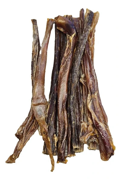 A bunch of dried pork pizzle sticks piled together.