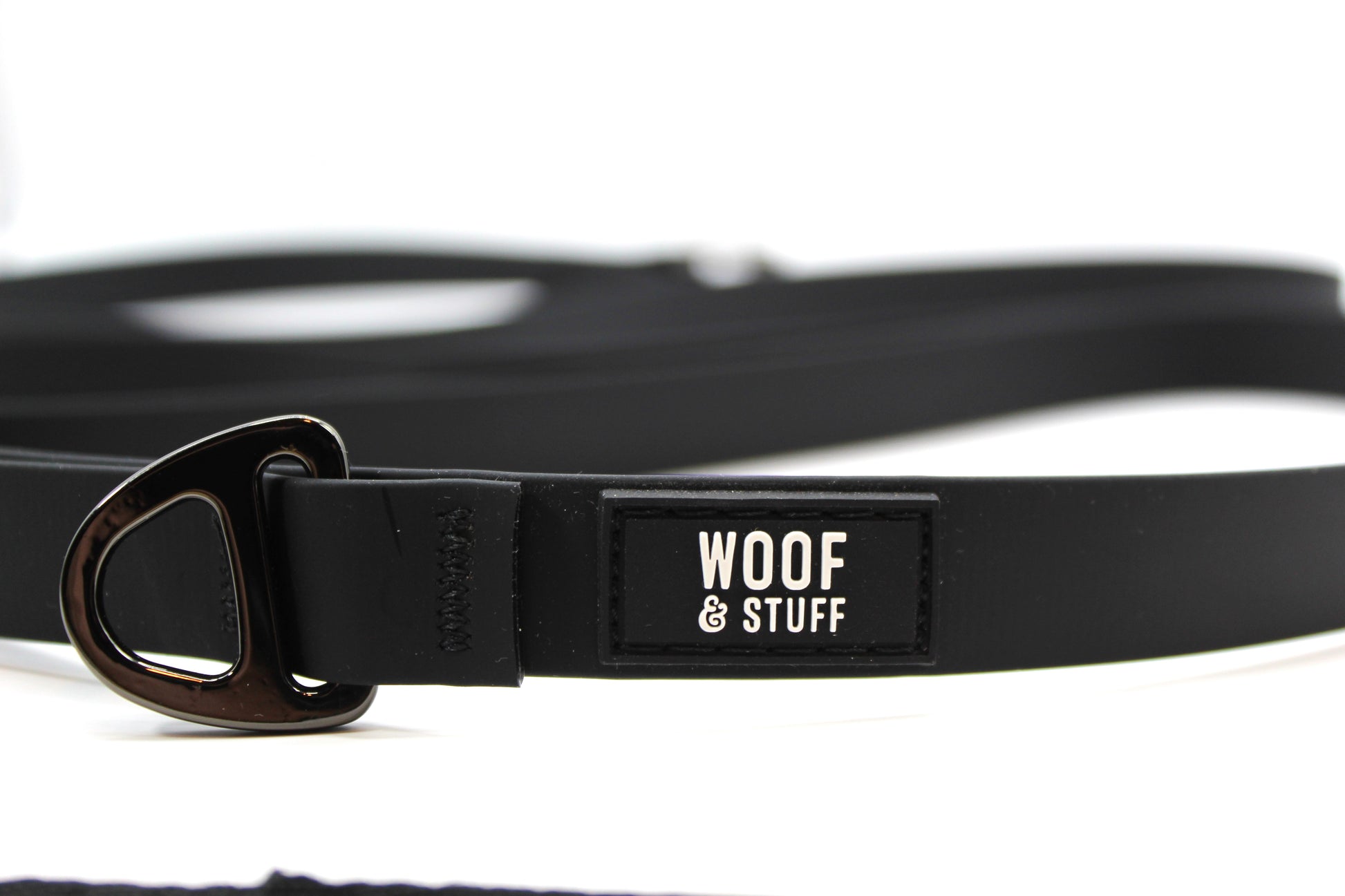 Black dog leash with 'Woof & Stuff' label.