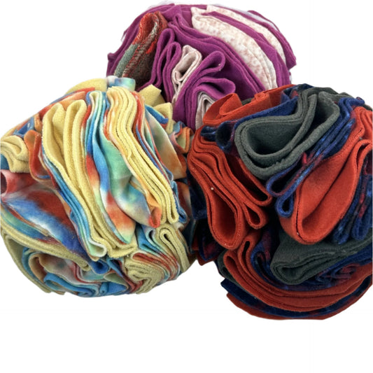 Three snuffle balls made of fabric with many folds to hide treats in